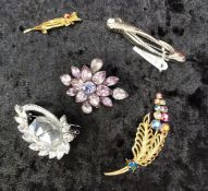 Group of vintage costume brooches, various materials.