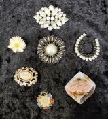 Group of vintage brooches, various materials.