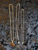 Group lot of white metal pendants and chains.