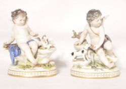 A pair of porcelain continental figurines of winged cherub / putti