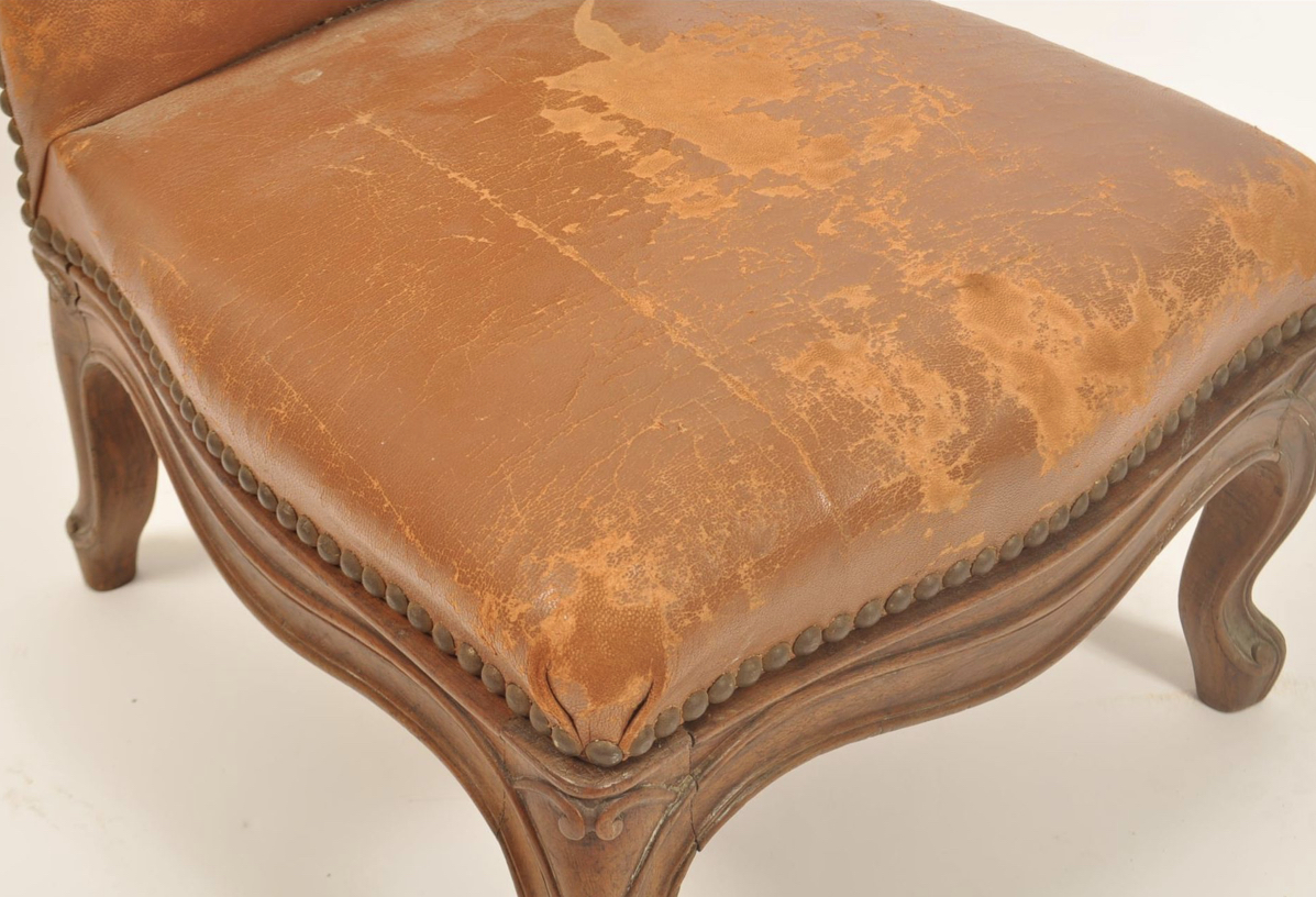 A 19th century oak and leather gout stool in the form of a French fauteuil. - Image 2 of 6