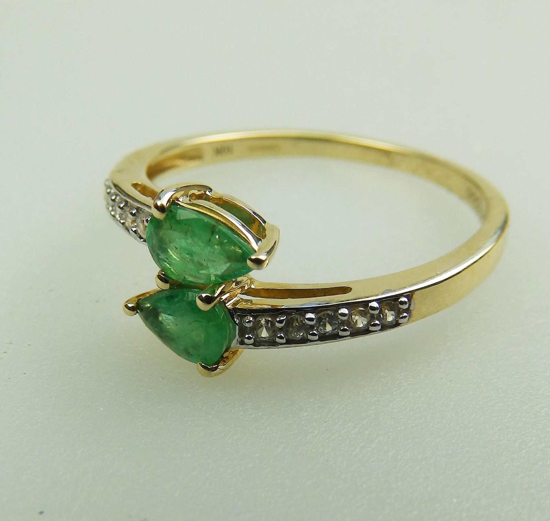 A 10ct gold, emerald and white topaz Crossover Ring, boxed