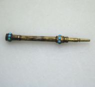 A gilt Mechanical retracting Propelling Pencil with turquoise stones C.19thC