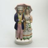 A good Staffordshire pottery Figure of a Courting Couple with parasol C.19thC