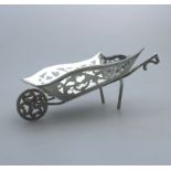 A miniature novelty solid silver Wheelbarrow pierced body, moving wheel C.1908