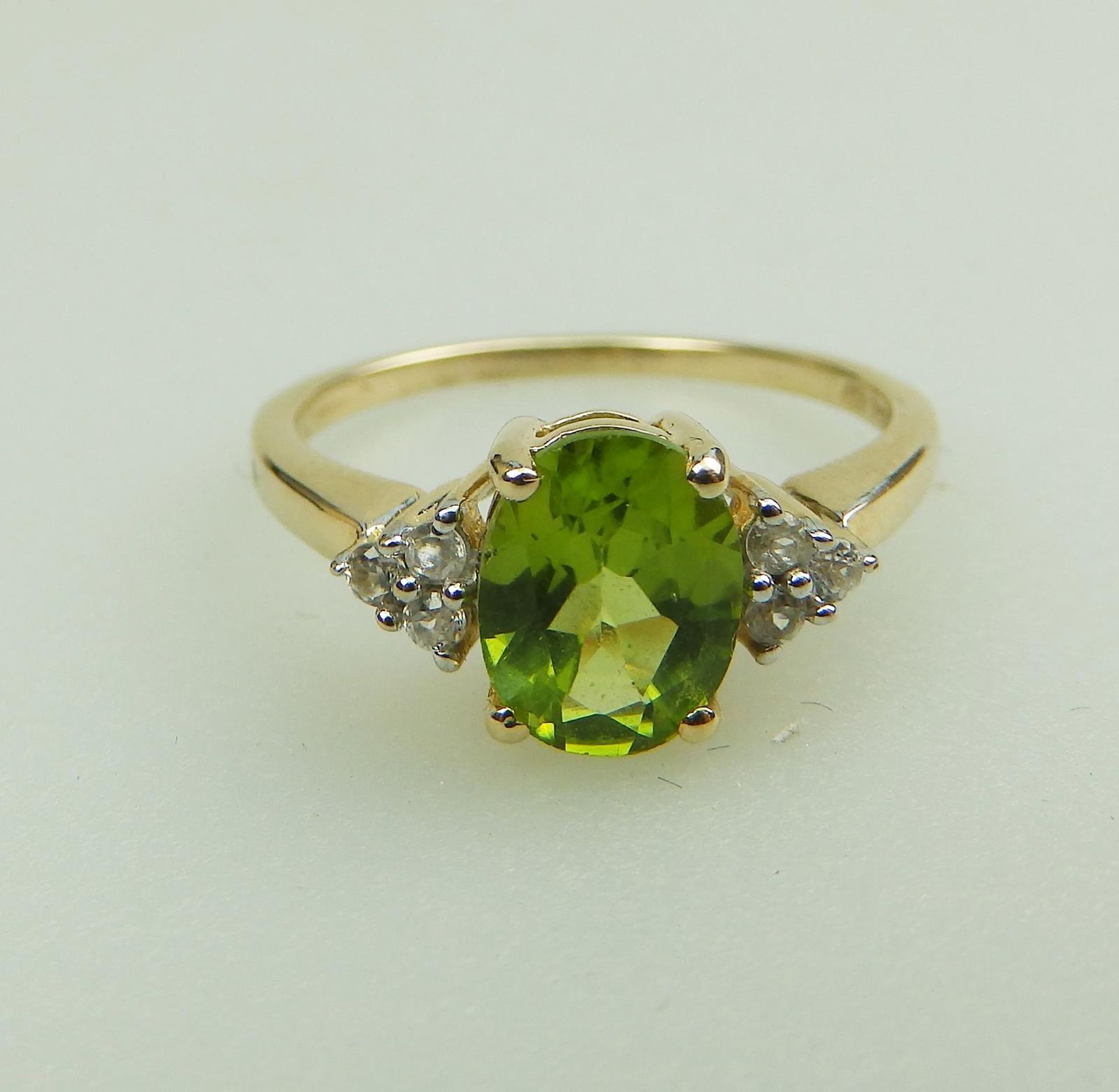 A 9ct gold, peridot and Diamond 7 stone Ring, boxed