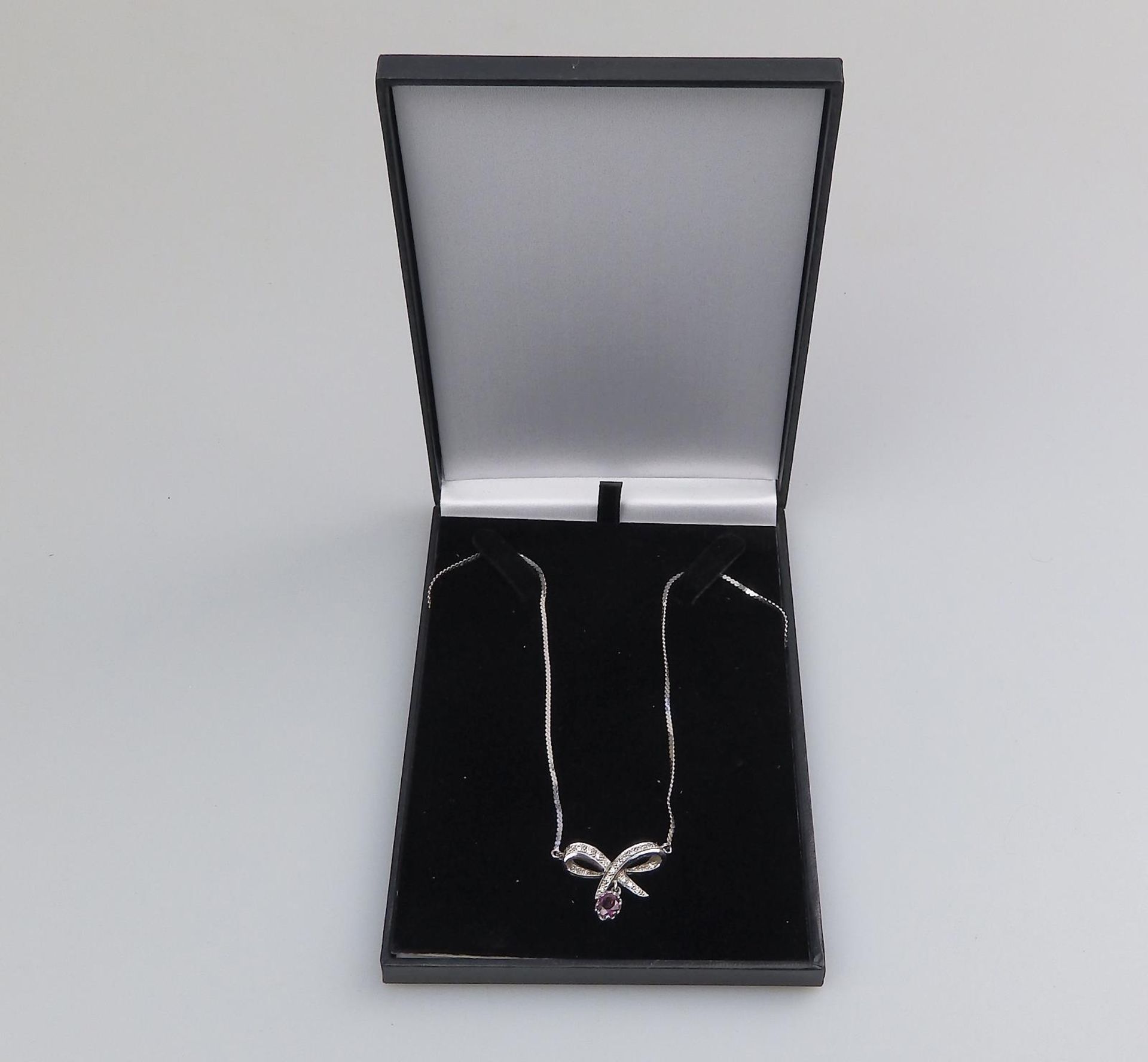 A 9 ct white gold and diamond & garnet pendant and chain, boxed - Image 3 of 4