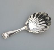 A solid silver Caddy Spoon, having shell bowl & terminal C.1915