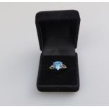 An unusual 9ct gold, blue topaz and diamond trapeze-shaped Ring, boxed