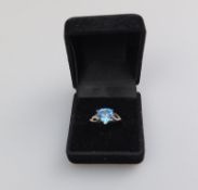 An unusual 9ct gold, blue topaz and diamond trapeze-shaped Ring, boxed