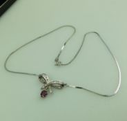 A 9 ct white gold and diamond & garnet pendant and chain, boxed