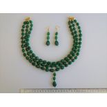 An Emerald Necklace With Matching Earrings