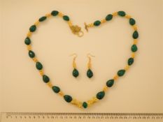 An Emerald Necklace And Earrings Set
