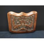 An antique Victorian carved mahogany panel.