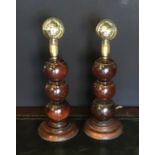 A pair of table lamps made from lignum vitae bowls on a turned oak base.