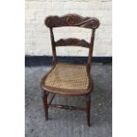 Antique carved back Victorian chair with caned seat.