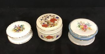 A group of three vintage ceramic lidded pots.