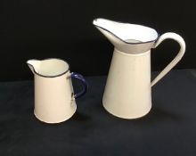 A pair of vintage metal enamelled jugs