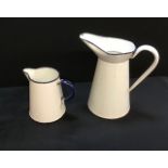 A pair of vintage metal enamelled jugs