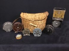 Assorted vintage fishing reels and wicker creel