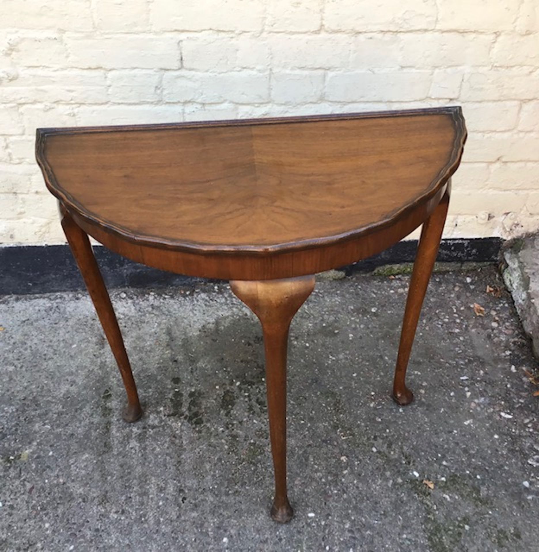 A victorian mahogany demi lune side table