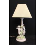 An antique porcelain cherub table lamp.