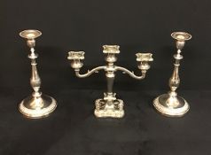 A silver plated heavy candelabra with a pair of silver plated candlesticks.