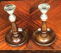 A pair of wooden and silverplate antique candlesticks