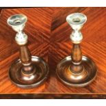 A pair of wooden and silverplate antique candlesticks