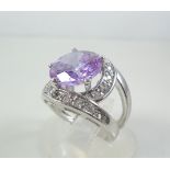 Silver ring with violet and white stones