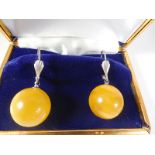 Silver earrings with natural amber ball