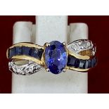 Yellow Metal Oval Tanzanite & Diamond Crossover Style Ring