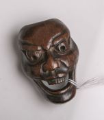 Holz-Netsuke (Provenienz wohl Japan, Alter unbekannt), wohl No-Maske, wohl sog.Men-Netsuke, aus