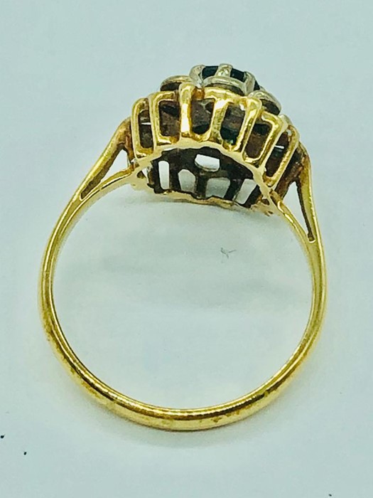 An 18ct yellow gold ring, centre claw set 5mm round sapphire with eight illusion set diamonds. - Image 5 of 10