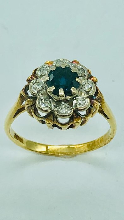 An 18ct yellow gold ring, centre claw set 5mm round sapphire with eight illusion set diamonds. - Image 3 of 10