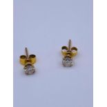 A pair of 1/4 ct diamond stud earrings