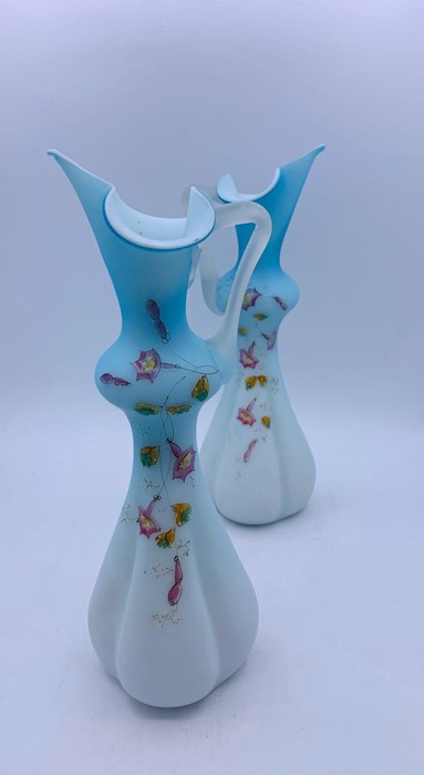 A pair of Victorian blue and white satin cased glass jugs with floral décor to front - Image 2 of 2