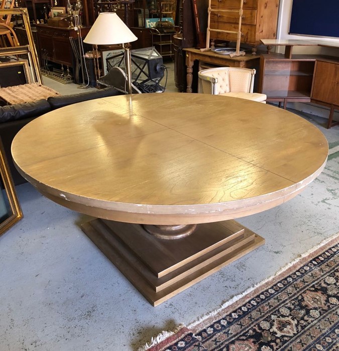 A Large round pedestal dining table on a large square base in light oak, 180 cm diameter. (marks