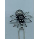 A silver spider necklace on silver chain