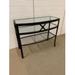A glass and metal console table