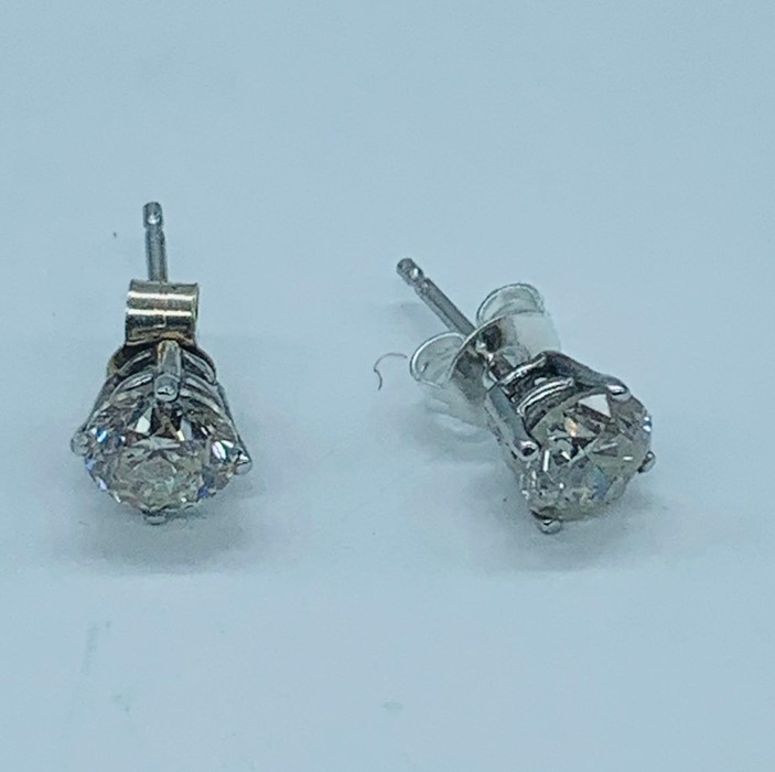 A fine pair of white gold diamond stud earrings of 1.21cts