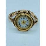 A Ladies decorative enamel watch with enamel face and 9ct gold strap.