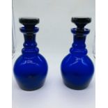 Two blue glass stoppered decanters