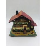 A Japanese musical jewellery box in the form of a house.
