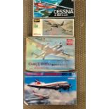 A selection of four boxed model aircraft kits by Humbrol, Bandai, Hasegawa and Supermodel