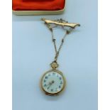 A Ladies gold pocket watch with enamel and semi precious stone decoration on a 9ct gold chain