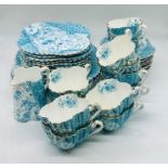 A pretty turquoise patterned part tea set to include two cake plates, eleven side plates, twelve