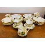 A Stoke Crescent part tea set to include 11 cups and saucers, milk jug, 12 side plates and 2 plates