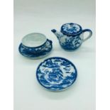 A 19th century Chinese teapot, cup and two saucers