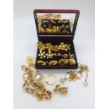 A quantity of gold coloured costume jewellery to include several pairs of clip on earrings
